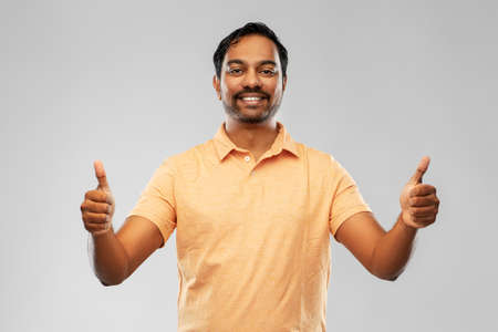 portrait of happy indian man showing thumbs up