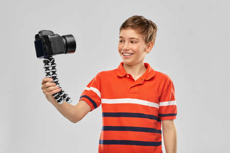 boy video blogger with camera and tripod