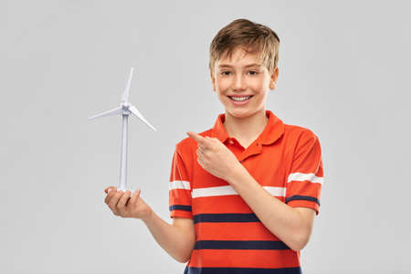happy smiling boy holding toy wind turbine