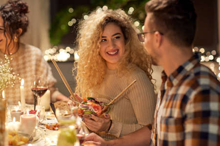 happy friends having christmas dinner at home