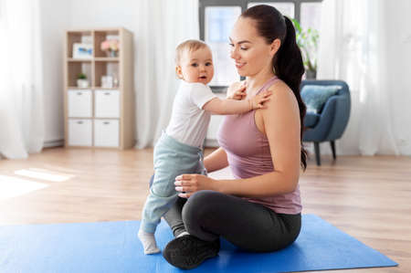 happy mother with little baby at home