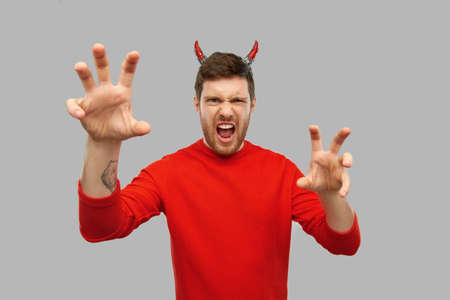 man in halloween costume of devil scaringの写真素材