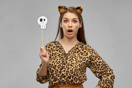 surprised woman in halloween costume of leopard