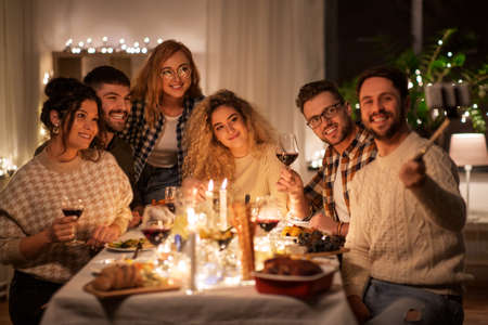 friends taking selfie at christmas dinner partyの写真素材