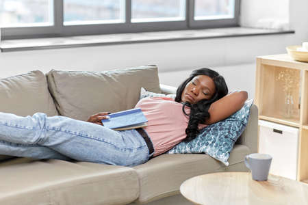 african american woman sleeping on sofa at home