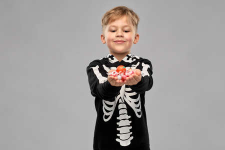 boy with candies trick-or-treating on halloween