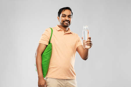 man with bag for food shopping and glass bottle