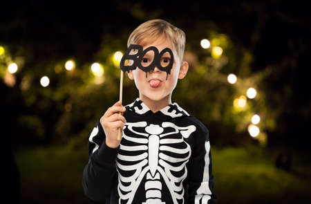 boy in halloween costume of skeleton making facesの写真素材