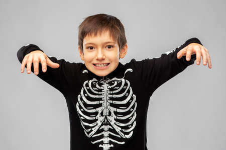 boy in halloween costume of skeleton frighteningの写真素材