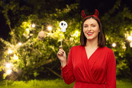 happy woman in red halloween costume of devil