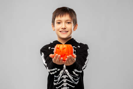 boy in halloween costume with jack-o-lanternの写真素材