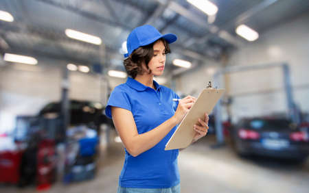 female worker with clipboard at car serviceの写真素材