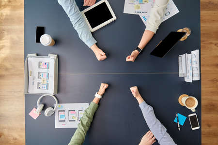 business team showing thumbs up at office tableの写真素材