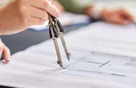 architect with blueprint and drafting compass
