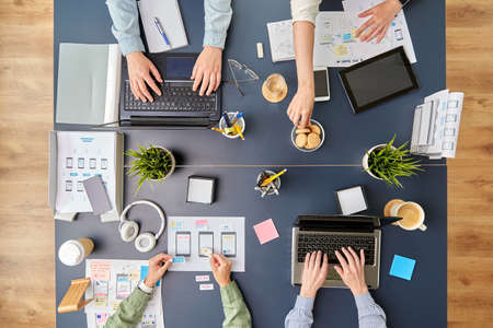 business team with gadgets working at office table