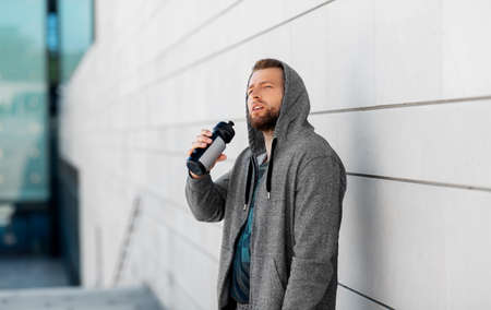 sportsman with bottle of water in cityの写真素材