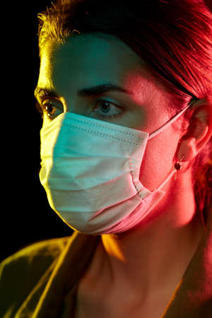 young woman wearing protective medical maskの写真素材