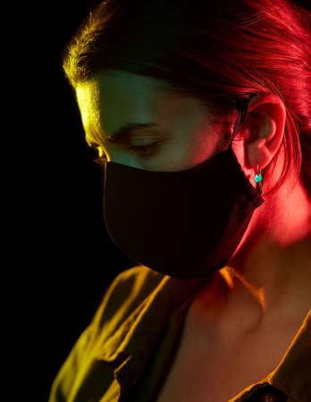 young woman wearing reusable protective maskの写真素材