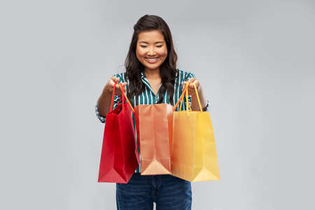 happy asian woman with shopping bags