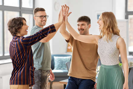 happy business team making high five at office