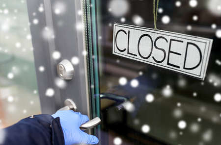 hand in medical glove holding to closed door