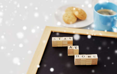 chalkboard with stay at home words on toy blocks