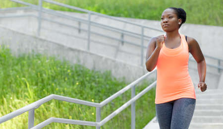 young african american woman running downstairs
