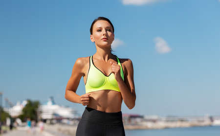 young woman running at seasideの写真素材