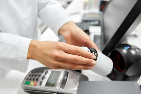 close up of pharmacist with medicine at pharmacyの写真素材
