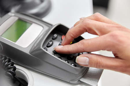 close up of hand with credit card in card-readerの写真素材