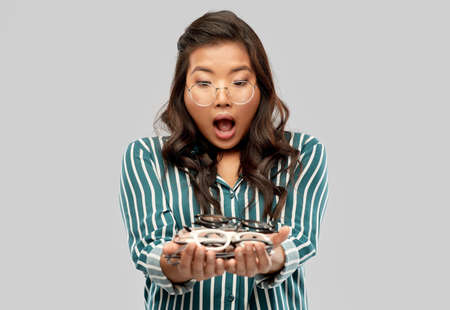 smiling asian woman in glasses or student