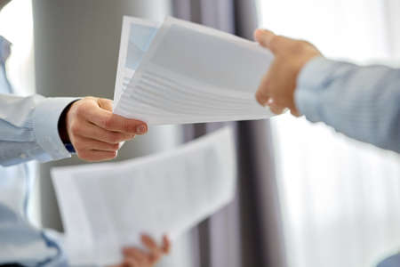 close up of business team with papers at officeの写真素材