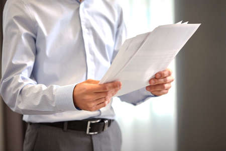 close up of businessman with papers at officeの写真素材