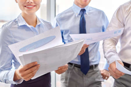 happy business team with papers meeting at office