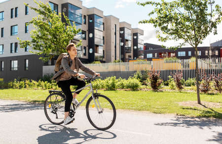 young man riding bicycle on city street