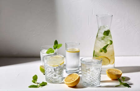 glasses with lemon water and peppermint on table