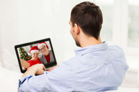 man having video call with family on christmasの写真素材