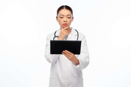 asian female doctor with tablet pc and stethoscopeの写真素材