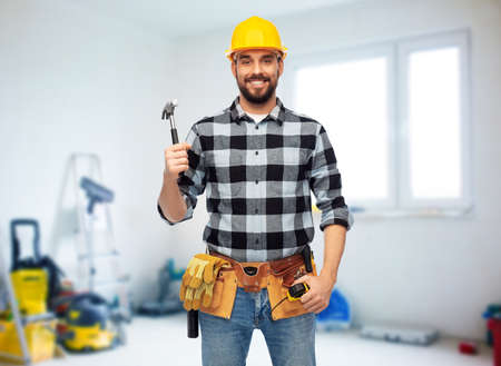 happy male builder in helmet with hammer