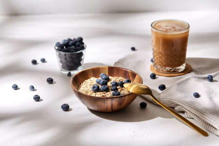 oatmeal with blueberries, spoon and coffee