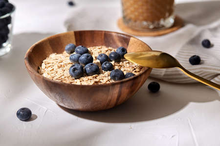 close up of oatmeal in bowl with blueberriesの写真素材