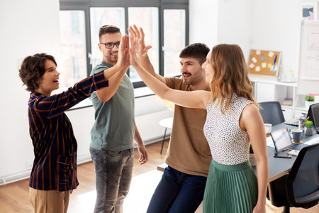 happy business team making high five at office