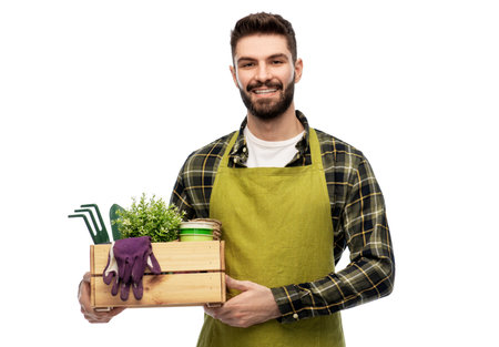 happy gardener or farmer with box of garden toolsの写真素材