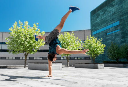 young man exercising and doing handstand outdoorsの写真素材
