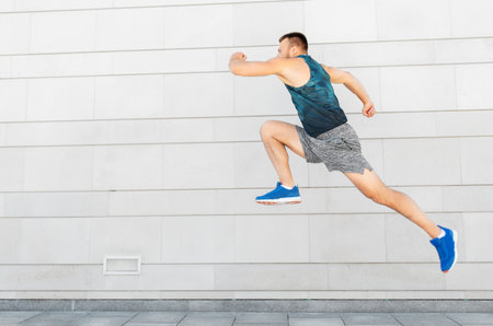 young man running or jumping outdoors