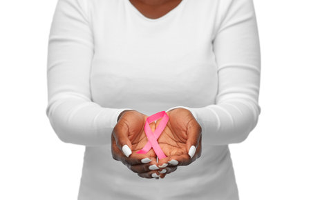 hands of woman with pink cancer awareness ribbonの写真素材