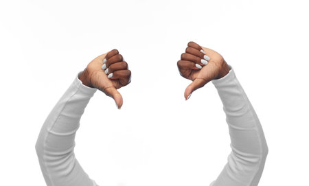 hands of african american woman with thumbs downの写真素材