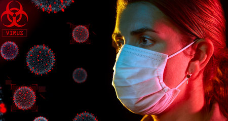 young woman wearing protective medical maskの写真素材