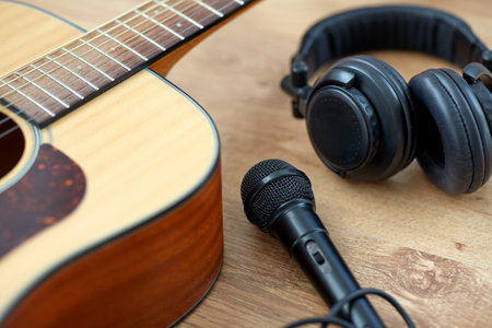 close up of guitar, microphone and headphones