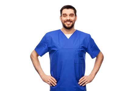 happy smiling doctor or male nurse in blue uniformの写真素材